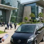 Minivans lined up for MICE logistics in Morocco in front of a congress centre in Rabat